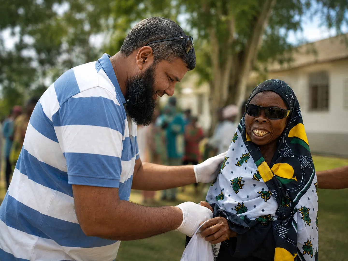 Optomed volunteer offering care and reassurance to a patient during community outreach